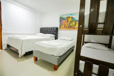 a room with two beds and a ladder at Hotel La Casona de Getsemani in Cartagena de Indias