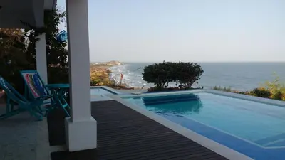 a swimming pool with a view of the ocean at Frente al Mar in Santa Veronica