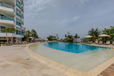 a large swimming pool next to a building at Escapada 5 estrellas frente al mar - sonest morros in Cartagena de Indias