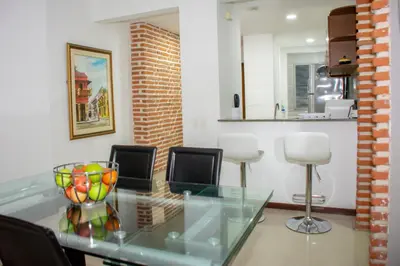 a dining room with a glass table and chairs at Mirador del Laguito 1201 in Cartagena de Indias