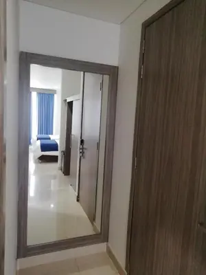 a bathroom with a mirror and a door in a room at Hotel Altamar Cartagena in Cartagena de Indias