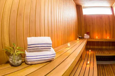 a sauna with a stack of towels on a chair at Hotel Altamar Cartagena in Cartagena de Indias