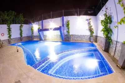 a swimming pool at night with blue water at Hotel Altamar Cartagena in Cartagena de Indias