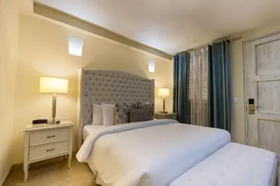 a bedroom with a large white bed and a window at Hotel Casa Canabal by Faranda Boutique in Cartagena de Indias