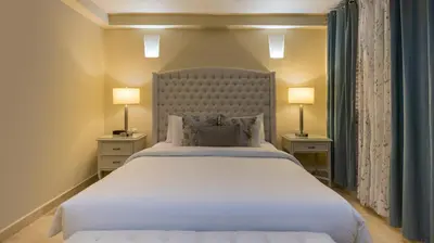 a bedroom with a large white bed with two lamps at Hotel Casa Canabal by Faranda Boutique in Cartagena de Indias