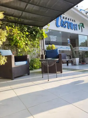 a patio with chairs and a table in front of a store at Costana - Hostal in Cartagena de Indias