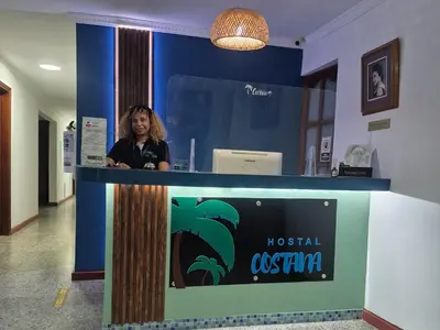 a woman standing behind a counter in a hospital exhibit at Costana - Hostal in Cartagena de Indias