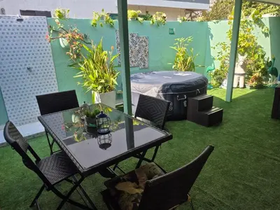 a patio with a table and chairs and a mattress at Costana - Hostal in Cartagena de Indias