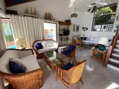 a living room with wicker chairs and a couch at Casa Miramar in Santa Marta