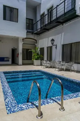 a pool in a hotel with chairs and tables at Hotel Virrey Cartagena in Cartagena de Indias