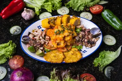a plate of food on a table with vegetables at Hotel Virrey Cartagena in Cartagena de Indias