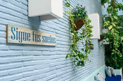 a sign on the side of a building with plants at Hotel Virrey Cartagena in Cartagena de Indias