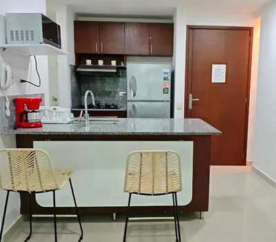 a kitchen with a counter and two bar stools at Edificio Morros Vitri in Cartagena de Indias