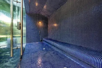 a swimming pool in a room with blue tiles at Edificio Morros Vitri in Cartagena de Indias