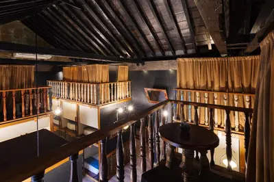 a view of a room with bookshelves and a table at The Clock Hostel & Suites in Cartagena de Indias