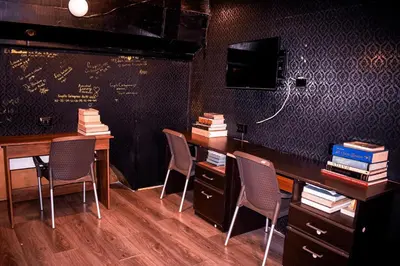 a classroom with chairs and a desk with books at The Clock Hostel & Suites in Cartagena de Indias