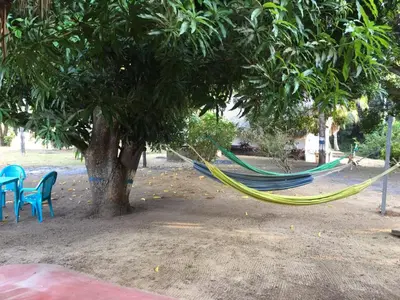 a hammock hanging from a tree in a park at Luna azul in San Bernardo del Viento