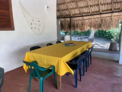 a dining room with a yellow table and chairs at Luna azul in San Bernardo del Viento