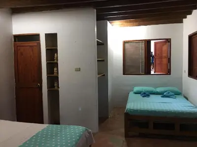 a bedroom with two twin beds and a window at Luna azul in San Bernardo del Viento