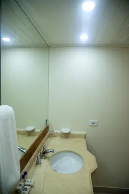 a bathroom with a sink and a mirror at Hotel Bahia Cartagena in Cartagena de Indias