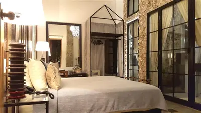 a bedroom with a large bed and a large window at Hotel Casa Lola Deluxe Gallery in Cartagena de Indias