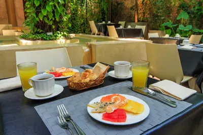 a table with plates of food and drinks on it at Hotel Casa Lola Deluxe Gallery in Cartagena de Indias