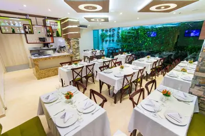 a dining room with white tables and chairs at Hotel Aixo Suites By GEH Suites in Cartagena de Indias