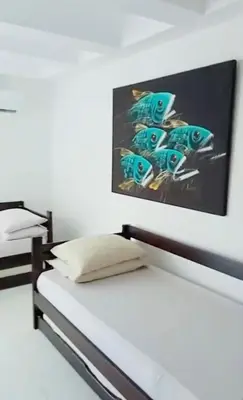 a bedroom with a bed with a painting on the wall at El Nuevo Conquistador in Cartagena de Indias