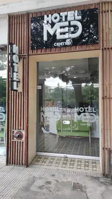 a store front with a reflection of a table in the window at Hotel Med Barranquilla Centro in Barranquilla