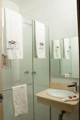 a bathroom with a glass shower and a sink at Hotel Med Barranquilla Centro in Barranquilla