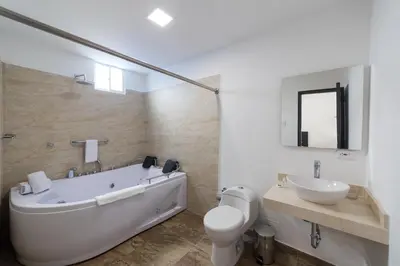 a bathroom with a tub and a toilet and a sink at Hotel G Cartagena in Cartagena de Indias
