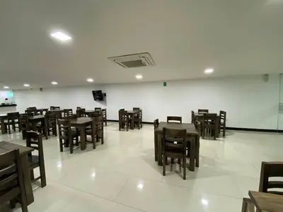 a dining room with wooden tables and chairs at Hotel G Cartagena in Cartagena de Indias