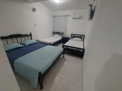 a bedroom with two twin beds and two chairs at Hotel Rosandy Galaxy in Cartagena de Indias