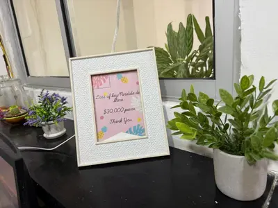 a picture frame sitting on a table with plants at Hotel Rosandy Galaxy in Cartagena de Indias