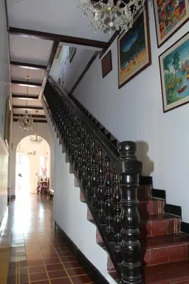 a staircase in a house with a chandelier at Hotel Casa Colonial in Barranquilla