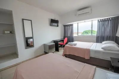 a hotel room with two beds and a window at Hotel Stil Cartagena in Cartagena de Indias