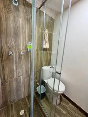 a bathroom with a toilet and a glass shower at Apartamentos Cartagena Colonial in Cartagena de Indias