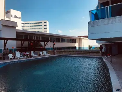 a swimming pool on the side of a building at Apartamentos Cartagena Colonial in Cartagena de Indias