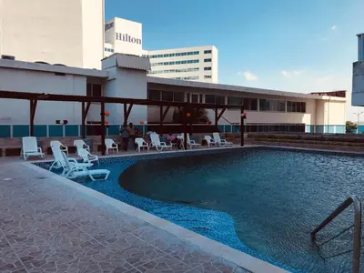 a swimming pool in front of a building at Apartamentos Cartagena Colonial in Cartagena de Indias