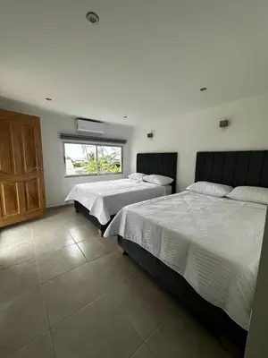 a bedroom with two beds and a window at Hotel Boutique Casa Berastegui in Puerto Colombia