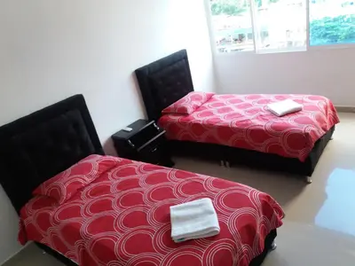 two beds sitting next to each other in a room at Hermosa vista Mar in Cartagena de Indias