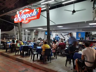a group of people sitting at tables in a restaurant at Hermosa vista Mar in Cartagena de Indias