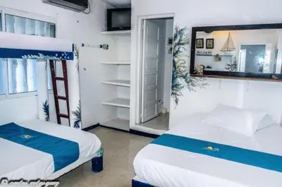 a bedroom with two beds and a mirror at Cabañas Los Juanchos Coveñas in Coveñas