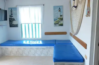 a blue bench in a room with a window at Cabañas Los Juanchos Coveñas in Coveñas