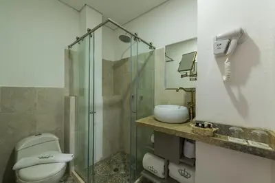 a bathroom with a shower and a toilet and a sink at Getsemani Cartagena Hotel in Cartagena de Indias