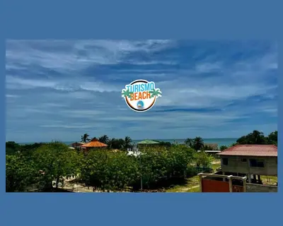 a sign for a pineappleeat restaurant under a cloudy sky at Palmares Beach in Tubará