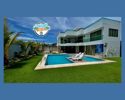 a villa with a swimming pool and a house at Palmares Beach in Tubará
