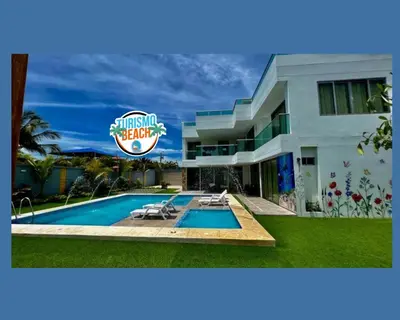 a house with a swimming pool and a sign at Palmares Beach in Tubará
