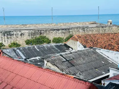 an aerial view of roofs of buildings and the ocean at Apartamento Alvarez in Cartagena de Indias