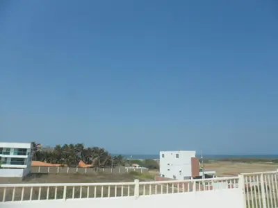 a view of the ocean from the balcony of a building at Cabaña Villa Flower Gold in Juan de Acosta